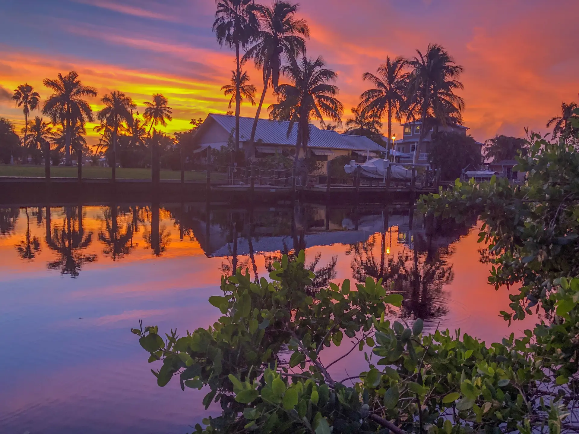Sunset over a palm-lined waterway in coastal Florida